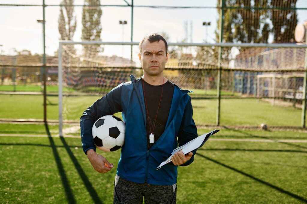 Portrait of confidence serious football coach looking at camera